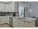 Well-equipped kitchen features stainless appliances, white cabinets, and an island with a sink at 6985 Shane Ln, Cumming, GA 30028