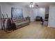 Bright, open living space with hardwood floors, comfortable seating, and an aquatic themed painting at 6985 Shane Ln, Cumming, GA 30028