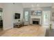 Cozy living room featuring a stone fireplace and hardwood floors for a warm, inviting atmosphere at 6985 Shane Ln, Cumming, GA 30028