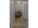 View of stairwell with hard wood floors and chair at the bottom of the stairs at 6985 Shane Ln, Cumming, GA 30028