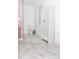 Bathroom with marble floors, white walls, toilet and a linen closet at 996 Palmetto Sw Ave, Atlanta, GA 30314