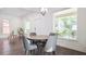 Well-lit dining room with modern table, grey chairs, and natural light from large windows at 996 Palmetto Sw Ave, Atlanta, GA 30314