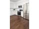Modern kitchen with stainless steel appliances, white cabinets, granite countertop and dark hardwood floors at 996 Palmetto Sw Ave, Atlanta, GA 30314