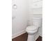 Compact powder room featuring toilet, small cabinet, and modern fixtures at 996 Palmetto Sw Ave, Atlanta, GA 30314