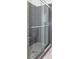 Shower with gray and stone tile, and a glass door at 996 Palmetto Sw Ave, Atlanta, GA 30314