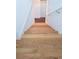 View of the wood stairs leading down with white walls and a railing at 996 Palmetto Sw Ave, Atlanta, GA 30314