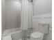 This bathroom includes a shower-tub combo, modern tile, and sleek fixtures at 2089 Quilt Ct, Lithonia, GA 30058