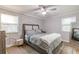 Well-lit bedroom featuring a ceiling fan, geometrically patterned accent wall, and hardwood floors at 2089 Quilt Ct, Lithonia, GA 30058