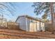 View of the side of the home with a deck and an air conditioning unit on a lot covered in leaves at 2089 Quilt Ct, Lithonia, GA 30058