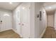 Bright hallway with multiple doorways and neutral walls and flooring at 2089 Quilt Ct, Lithonia, GA 30058