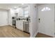 Clean, modern kitchen with white cabinets, stainless steel appliances, and wood-look flooring at 2089 Quilt Ct, Lithonia, GA 30058