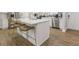 Modern kitchen island with bar seating, stainless steel appliances, and bright white cabinets at 2089 Quilt Ct, Lithonia, GA 30058