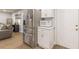 Efficient kitchenette area with stainless steel refrigerator, microwave, and white cabinetry at 2089 Quilt Ct, Lithonia, GA 30058