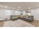 Spacious living area featuring a large sectional, patterned rug, and ample natural light from multiple windows at 2089 Quilt Ct, Lithonia, GA 30058