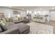 Spacious living space featuring a sectional sofa, large carpet, and kitchen with island at 2089 Quilt Ct, Lithonia, GA 30058