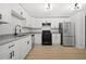 Modern kitchen featuring white cabinets, granite countertops, stainless steel appliances, and a hardwood floor at 2277 Cloverdale Se Dr, Atlanta, GA 30316