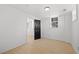 Bright room with hardwood floors, white walls, a window, and a modern interior door at 2277 Cloverdale Se Dr, Atlanta, GA 30316