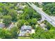 Aerial view showcases home with large pool, patio, landscaping, and nearby roads at 2903 Ashebrooke Ne Dr, Marietta, GA 30068