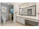 Well-lit bathroom features white vanity, an elongated mirror, and a glass-enclosed shower at 2903 Ashebrooke Ne Dr, Marietta, GA 30068