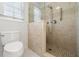 Full bathroom featuring walk-in shower with glass surround, neutral tile, and toilet at 2903 Ashebrooke Ne Dr, Marietta, GA 30068