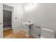 Powder room with pedestal sink, ceramic tile, and easy access to attic storage at 2903 Ashebrooke Ne Dr, Marietta, GA 30068