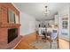 Dining area with fireplace, chandelier, hardwood floors, and view into kitchen at 2903 Ashebrooke Ne Dr, Marietta, GA 30068