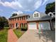 Charming brick home featuring a two-car garage and a walkway to the front door at 2903 Ashebrooke Ne Dr, Marietta, GA 30068