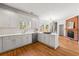Spacious white kitchen featuring modern appliances, hardwood floors, and a view of the brick fireplace at 2903 Ashebrooke Ne Dr, Marietta, GA 30068