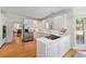 Modern kitchen with white cabinets, stainless appliances, hardwood floors, and natural light at 2903 Ashebrooke Ne Dr, Marietta, GA 30068