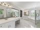 Elegant bathroom features marble floors, dual vanities, a soaking tub, and glass shower at 2903 Ashebrooke Ne Dr, Marietta, GA 30068