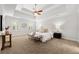 Bright primary bedroom with carpet, a tray ceiling, and ample natural light at 2903 Ashebrooke Ne Dr, Marietta, GA 30068