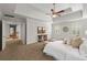 Spacious primary bedroom features a tray ceiling, fan, and a connecting hallway at 2903 Ashebrooke Ne Dr, Marietta, GA 30068
