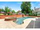 Beautiful pool with spa and brick accents is surrounded by lush landscaping for a private oasis at 2903 Ashebrooke Ne Dr, Marietta, GA 30068