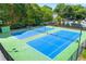 Aerial view of tennis courts showcases well-maintained athletic facilities with a nearby pool at 2903 Ashebrooke Ne Dr, Marietta, GA 30068
