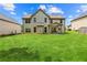 Expansive backyard showcasing a lush lawn, rear home elevation, and comfortable outdoor living space at 7946 White Oak Loop, Stonecrest, GA 30038