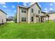 Spacious backyard with green grass, featuring an outdoor seating area with a covered porch at 7946 White Oak Loop, Stonecrest, GA 30038
