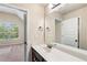 Bathroom with double sinks, and view into bedroom at 7946 White Oak Loop, Stonecrest, GA 30038