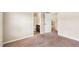 Open bedroom with plush carpeting that showcases views of the bathroom and additional room at 7946 White Oak Loop, Stonecrest, GA 30038
