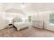 Bright bedroom with vaulted ceilings, neutral color palette, and large windows at 7946 White Oak Loop, Stonecrest, GA 30038
