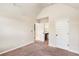 Inviting bedroom featuring neutral walls, plush carpeting, and doorways to the bathroom and closet at 7946 White Oak Loop, Stonecrest, GA 30038
