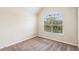 Bright bedroom with neutral walls, plush carpeting, and a large window offering natural light at 7946 White Oak Loop, Stonecrest, GA 30038