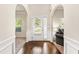 Bright entryway featuring gleaming hardwood floors, arched doorways, and a view into a cozy living area at 7946 White Oak Loop, Stonecrest, GA 30038