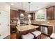 Stylish kitchen with granite countertops, dark wood cabinets, stainless steel appliances, and a central island at 7946 White Oak Loop, Stonecrest, GA 30038