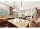 Open-concept kitchen featuring granite countertops, dark cabinetry, and an island, seamlessly connected to dining area at 7946 White Oak Loop, Stonecrest, GA 30038