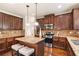 Beautiful kitchen featuring dark wood cabinets, stainless steel appliances, and granite countertops with an island at 7946 White Oak Loop, Stonecrest, GA 30038