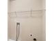 Practical laundry room with essential hookups and a convenient wire shelf for storage at 7946 White Oak Loop, Stonecrest, GA 30038