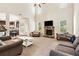 Open-concept living room with a stone fireplace and views of the kitchen and backyard at 7946 White Oak Loop, Stonecrest, GA 30038