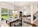 Bright living room featuring high ceilings, a fireplace, and an adjacent dining area with a table set for four at 7946 White Oak Loop, Stonecrest, GA 30038