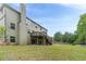 Expansive backyard with mature trees, a deck, and outdoor space at 1022 Nestling Dr, Lawrenceville, GA 30045