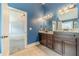 Bathroom with granite vanity, dark wood cabinetry, tile floor, and a mirror with decorative lighting at 1022 Nestling Dr, Lawrenceville, GA 30045